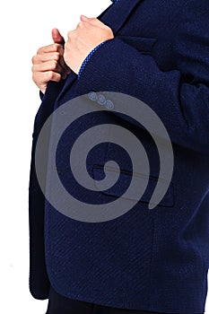 Boy in a school uniform on a white background. The boy demonstrates a black jacket