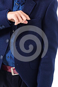 Boy in a school uniform on a white background. The boy demonstrates a black jacket