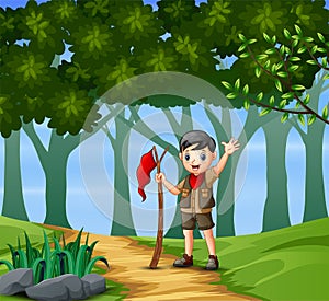 Boy scout hiking in the forest background