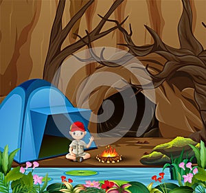 Boy scout sitting at camping site