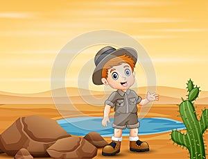 Boy scout by the small pond at the desert