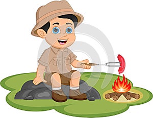 Boy Scouts grilling sausages while camping