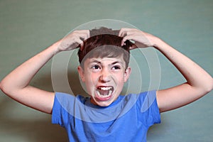 Boy scratch his head isolated on blue