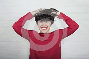 Boy scratching his hair for head lice