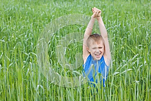 Boy screaming in the grass