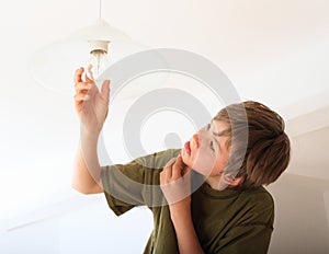 Boy screwing bulb