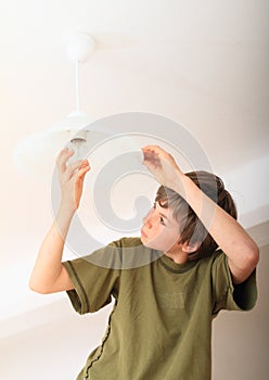 Boy screwing bulb
