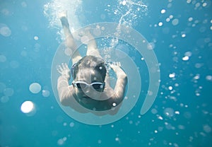 The boy in the sea swimming under water