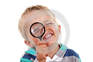 Boy searching with magnifying glass