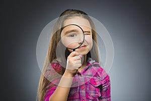 Boy See Through Magnifying Glass, Kid Eye Looking with Magnifier Lens over Gray