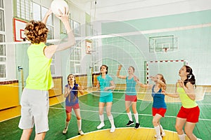 Boy serving jump float during volleyball match