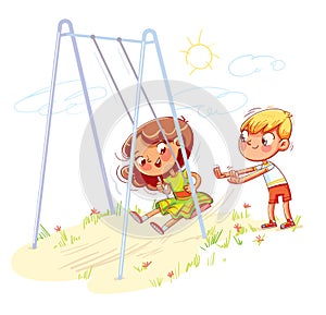 Boy shakes the girl on a swing at the playground