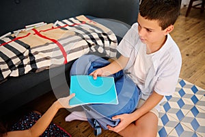 Boy sharing a blue notebook