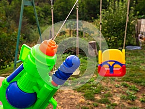 Boy shooting water dispersion with water gun