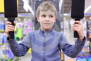 Boy in shop on sports exerciser photo