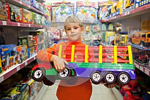 Boy in shop with toy truck