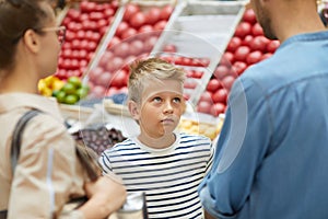 Boy Shopping with Parents in Supermarket