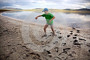 Boy on the shore of salt lake