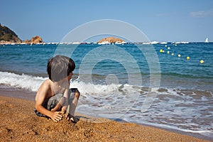 Boy on the shore of sea