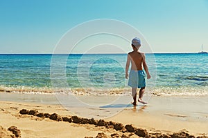 Boy on the shore of the sea.