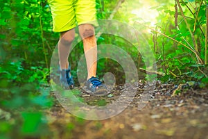 Boy in shorts walking in woods in summer