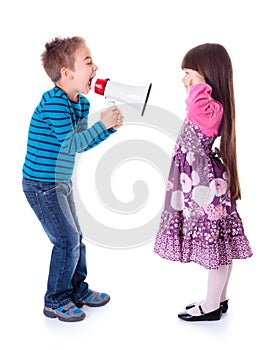 Boy shouting at girl with megaphone