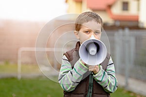 Boy shouts something into the megaphone
