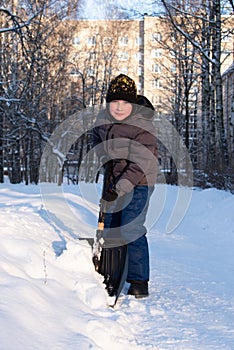 A boy with a shovel in winter in St. Petersburg