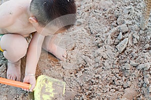 Boy shoveling sands