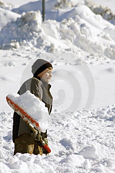 Boy shoveling snow