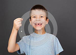 Boy show lost tooth on thread