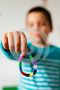 Boy showing friendship bracelet
