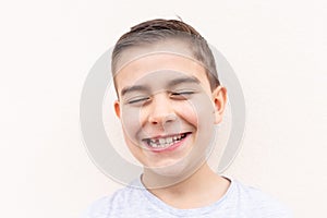 boy showing his lost milk tooth, close up