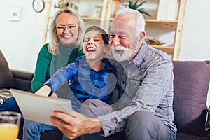 Boy showing his older grandparents new technology