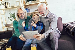 Boy showing his older grandparents new technology