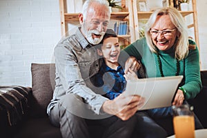 Boy showing his older grandparents new technology