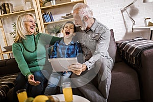 Boy showing his older grandparents new technology