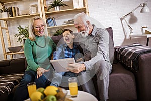 Boy showing his older grandparents new technology