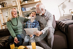 Boy showing his older grandparents new technology