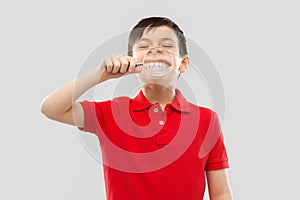 Boy showing his teeth through magnifying glass