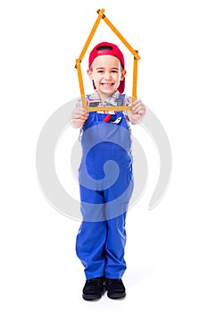 Boy showing house made of measuring ruler