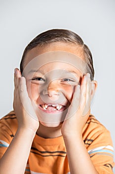 Boy showing missing teeth.