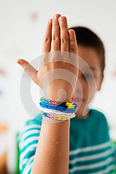 Boy showing rubber bracelets