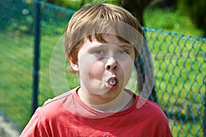 Boy shows his tongue