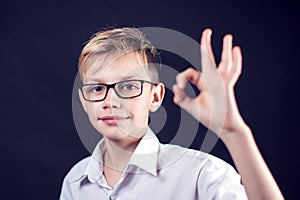 A boy shows ok gesture. People and emotions concept