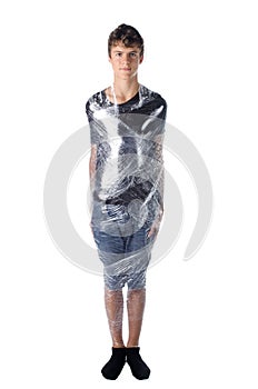 Boy shrinkwrapped on cellophane