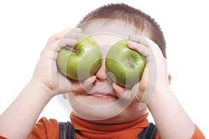 Boy shutting eyes with apples photo