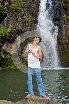 Boy singing at waterfall