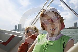 Boy With Sister On Yacht Against Sky
