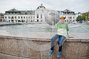 Boy sit on fountain at Grassalkovich Palace, Bratislava, Europe. Residence of the president of Slovakia in Bratislava